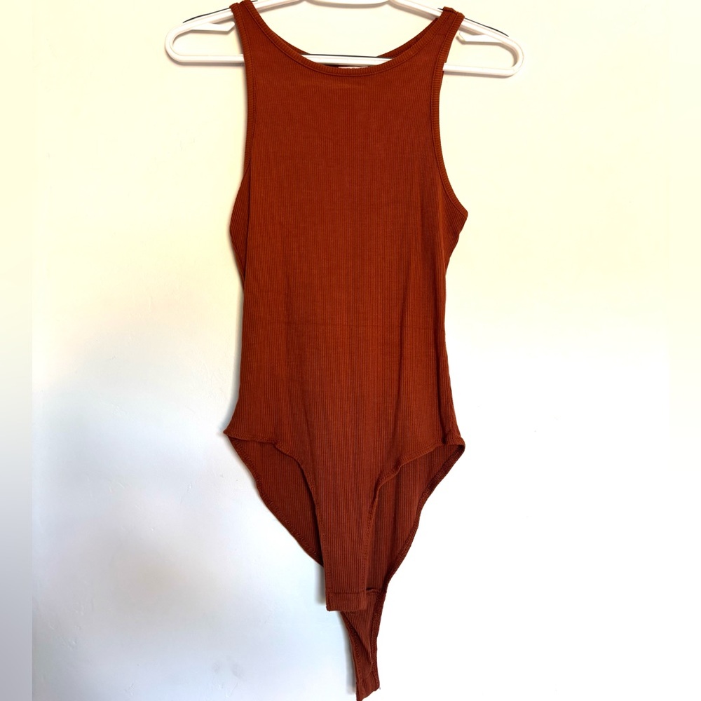 Brand is Selfie, size small, color is burnt orange. The material is ribbed.